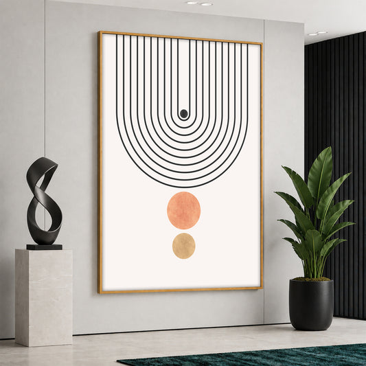 A vertical canvas print in a wooden frame featuring black bohemian arch lines and two earth-toned circles on a white background, hanging in a bright modern room.