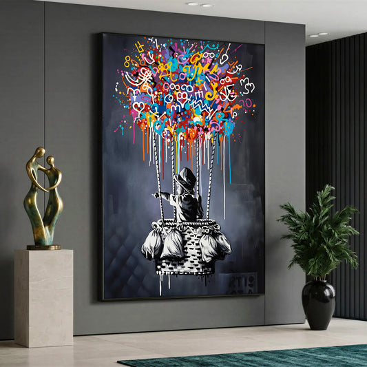 A street art style canvas painting depicting a black and white figure of a boy pointing forward from a hot air balloon basket, with the balloon itself made of vibrant, multicolored graffiti, scribbles, and paint drips against a dark grey background.