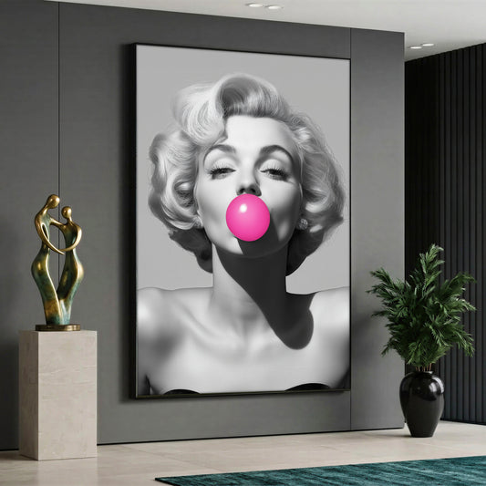 Large vertical black and white canvas print of Marilyn Monroe blowing a pink bubble gum, styled in a modern grey interior living room.
