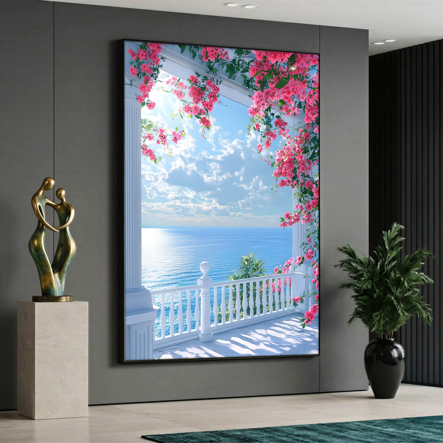 A view of a blue ocean and bright sky with white clouds from a white balconied terrace with columns, framed by vibrant pink bougainvillea flowers hanging from above.
