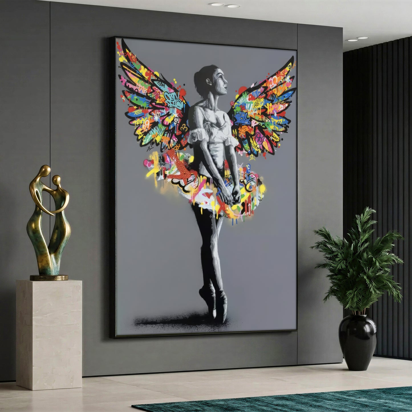 A street art style canvas painting depicting a monochrome black and white ballerina standing on her toes against a solid grey background, featuring a tutu and large angel wings covered in vibrant, multicolored graffiti and splashes of paint.