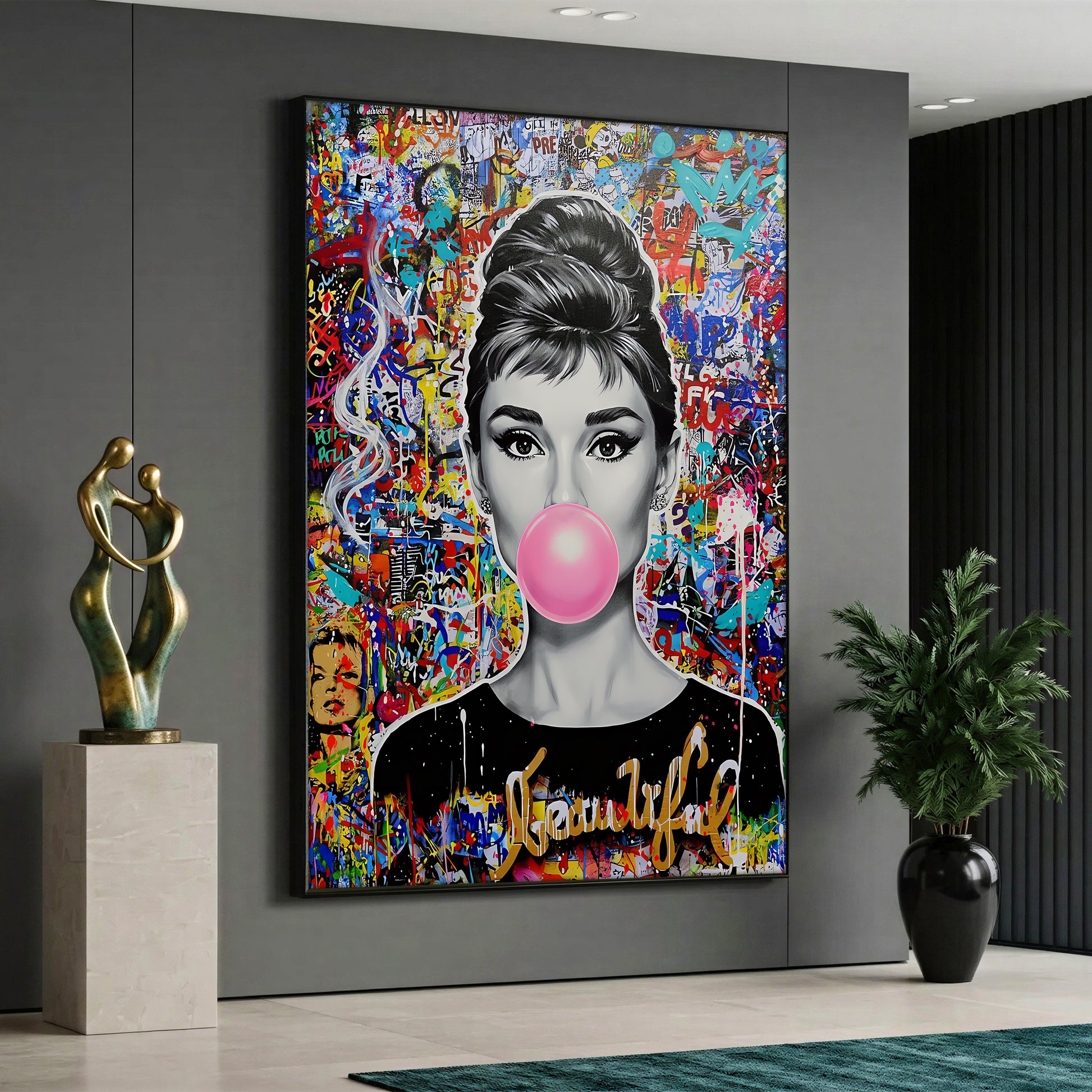 A pop art style canvas painting depicting a black and white portrait of Audrey Hepburn blowing a pink bubble gum against a vibrant, multicolored graffiti and street art background.