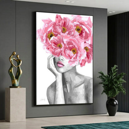Large vertical canvas print of a black and white woman silhouette with large pink peony flowers blooming from her head, styled in a modern interior.