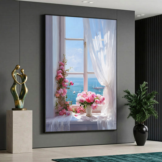 A view through an open white window showing a blue sea with boats, featuring a vase of pink roses and climbing pink flowers on the windowsill next to a blowing white sheer curtain.