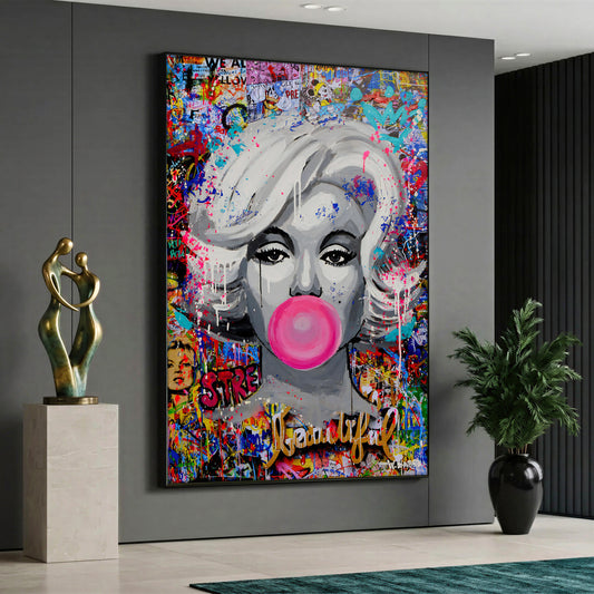 A pop art style canvas painting depicting a black and white portrait of Marilyn Monroe blowing a pink bubble gum against a vibrant, multicolored graffiti and street art background.