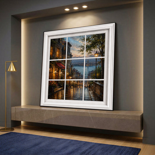 A square canvas wall art designed as a white window frame looking out onto a rainy Istanbul street at dusk with the Bosphorus, displayed on a grey console.